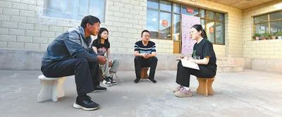 陈果（右一）在农户家中了解今年蚕豆种植情况。葸陇强  摄