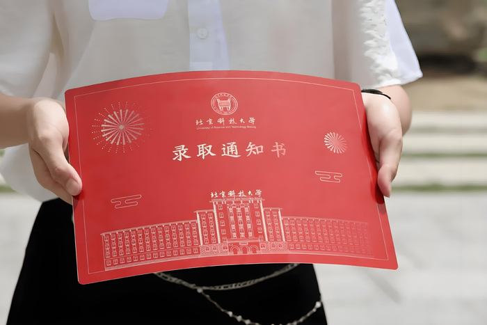 今年北大录取通知书以京师大学堂牌匾为设计灵感,在红底色的衬托下