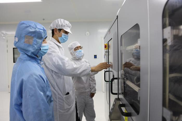 安徽丰芯半导体有限公司的生产车间内，工人们正在查看设备运行状况。（受访者供图）