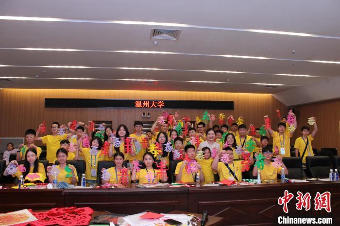 近日，2024年“中国寻根之旅”夏令营温州大学营，营员展示剪纸作品。　(受访者供图)