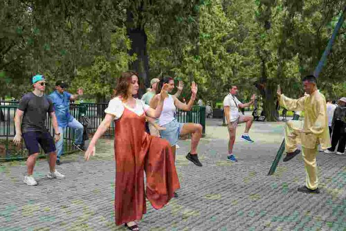   7月9日，几名来自意大利的游客在北京天坛公园体验练习太极拳。新华社记者 鞠焕宗 摄