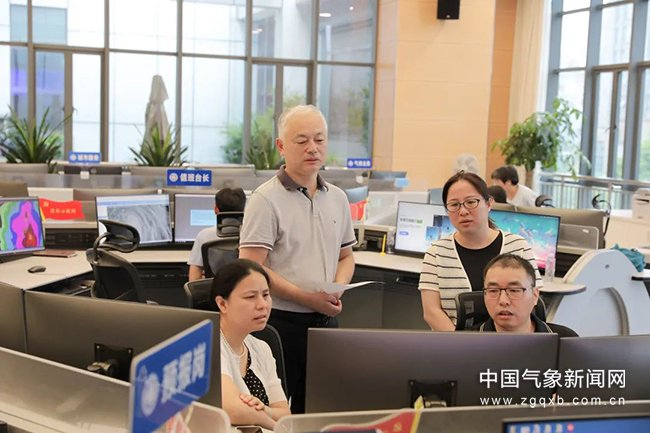 7月24日，省气象台预报员讨论台风“格美”发展动态。图/廖玥 文/谢玉丽