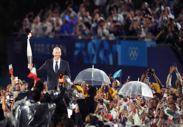 ↑在开幕式上，法国前职业足球运动员齐达内在特罗卡德罗广场传递火炬。新华社记者 王毓国 摄
