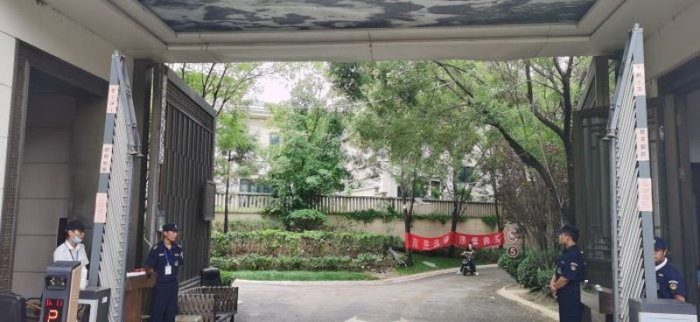 7月25日北湖壹号小区大门口的两方保安。 董红艳/摄