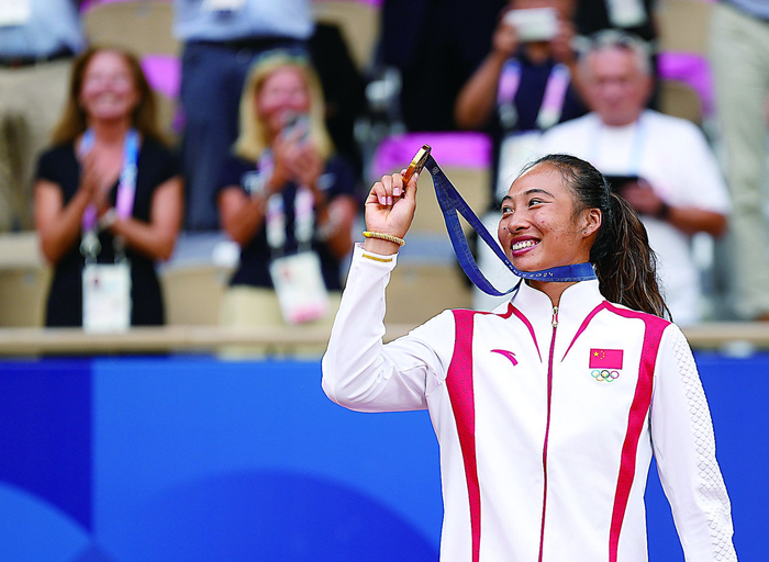     郑钦文在颁奖仪式上展示金牌