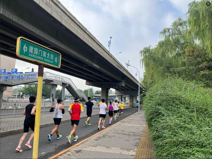 图为跑步爱好者在北京街头晨跑。(栾雨石/摄) 