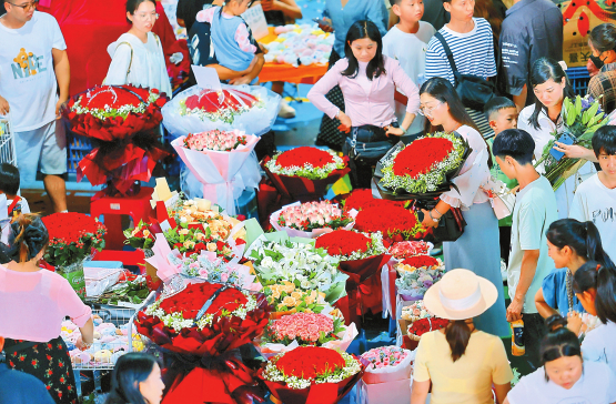 市民游客在昆明斗南花卉市场购买玫瑰花束。 记者 胡妤雅 摄