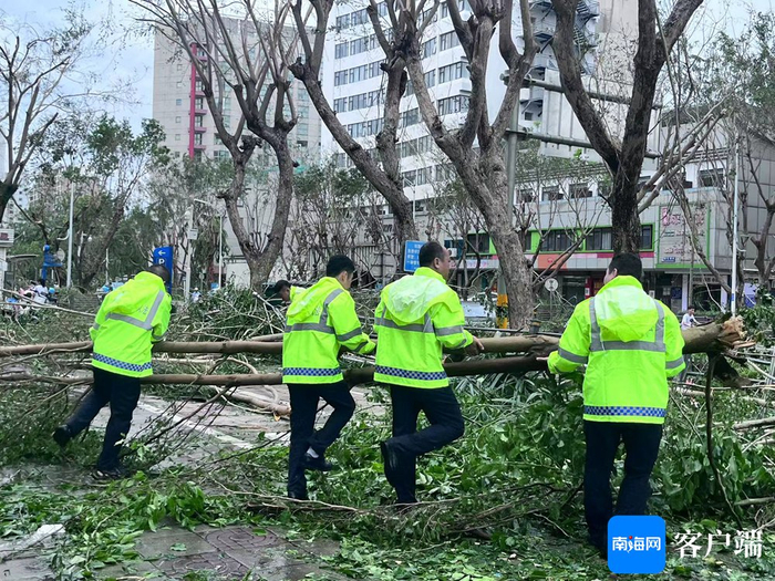 工作人员正在路面清理路障。记者 王威 摄