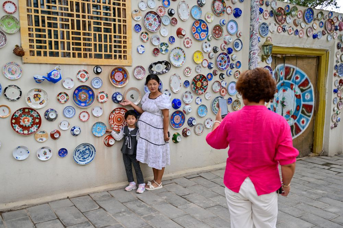   游客在新疆库车市龟兹小巷拍照留念。新华社记者 丁磊 摄