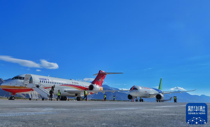 2024年9月19日，一架C919飞机（右）与一架ARJ21飞机停放在西藏拉萨贡嘎国际机场停机坪上。