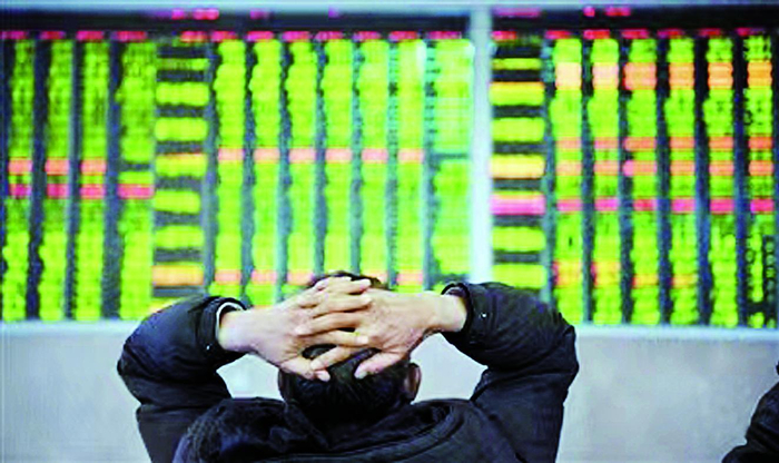     股民在证券交易大厅内关注股市行情