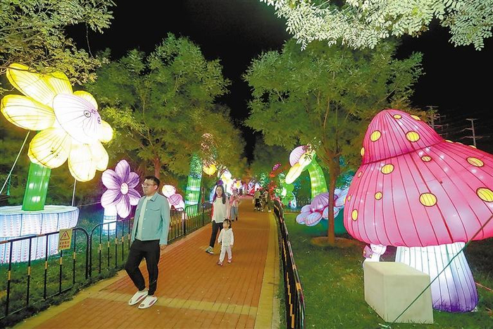 图为游客在御龙河千灯会游玩。