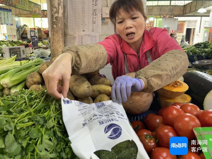 农贸市场里，许多摊位用上了全生物降解的塑料袋。记者 谭琦 摄