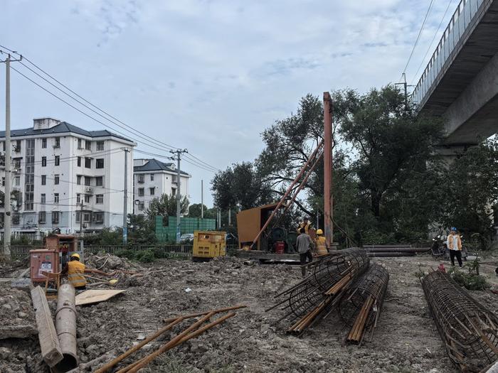 △绿地近莘松路尽头处，几名身着“中国铁建”黄色马甲的工人正在施工忙碌。