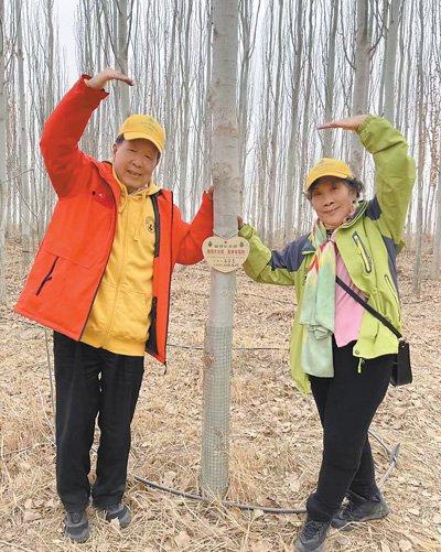 今年3月，李德仁（左）和朱宜萱在生态林合影。　　受访者供图