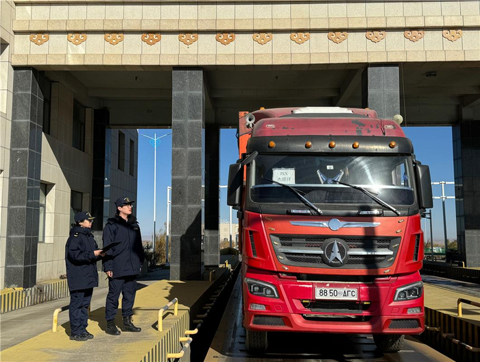 　包头海关关员引导载运首票进境保税维修发动机的车辆通过海关卡口。