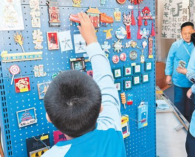 一名儿童在2024年北京地坛书市上选购冰箱贴。　　本报记者 尹 婕摄