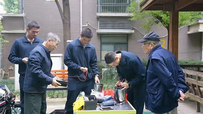 姚文正带领学员为居民维修电器。合肥市蜀山区委宣传部供图