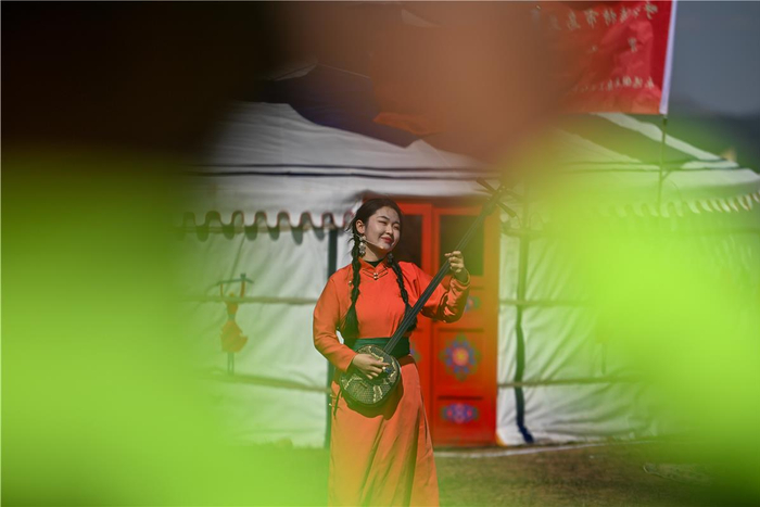 乌兰牧骑队员为群众演出。