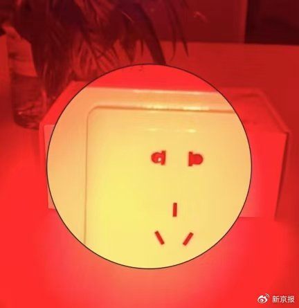 昏暗环境下，防偷拍检测仪器检测到针孔摄像头时，会反射出红色光点（左侧插孔）。 受访者供图