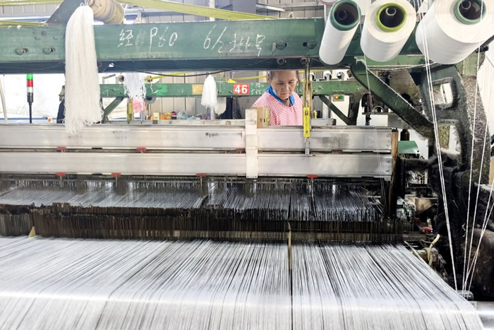 工人们正手法熟练地操作着生产设备（央广网记者  徐鹏  摄）