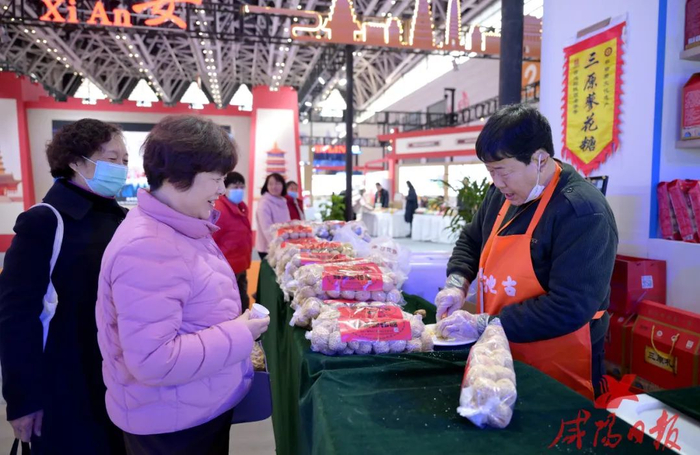 第五届中国西部国际采购展览会咸阳展馆内，游客在购买三原蓼花糖。