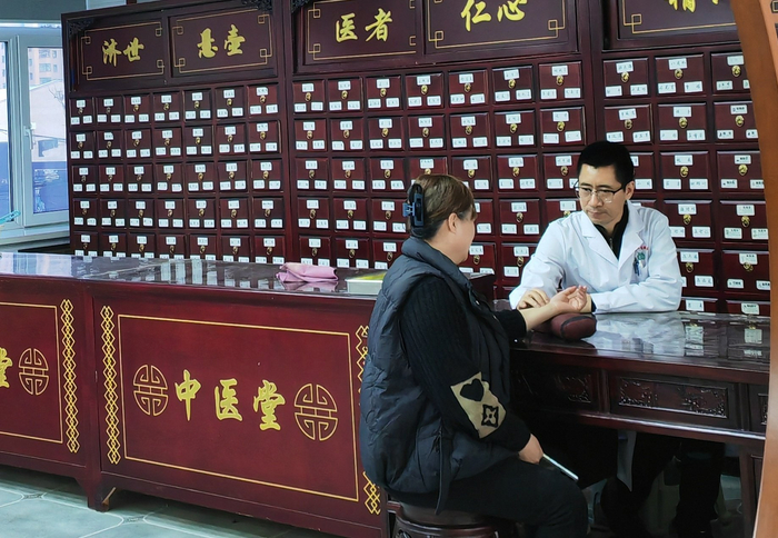 社区中医把诊号脉（央广网记者  陈显春  摄）