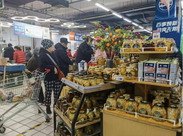 　　图为消费者在超市选购罐头。