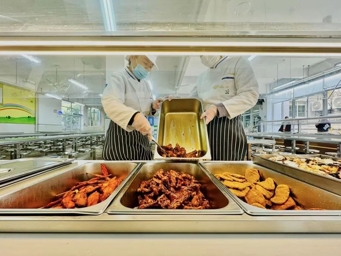 餐品岛台下的电炉正在加热，菜肴热腾腾的。