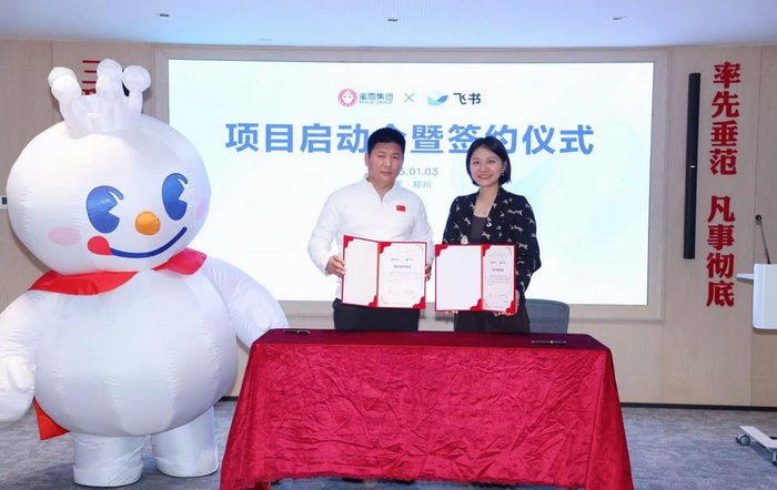 图为蜜雪冰城事业群总经理时朋与飞书首席商业官林婵签约