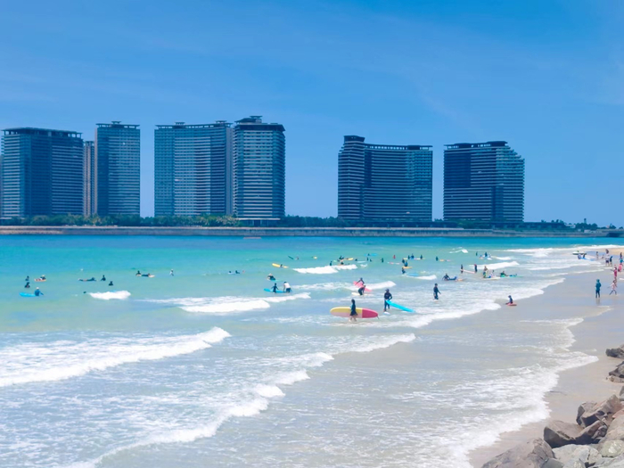 游客在日月湾冲浪。记者 张野 摄