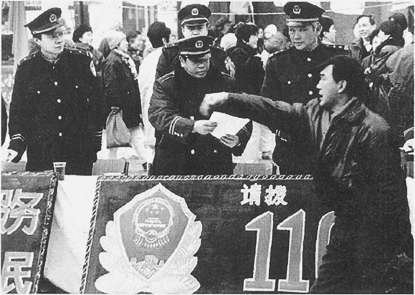  1998年，市公安局在全市64处设立咨询宣传点，公安干警走上街头向过往群众宣传110报警服务台。程玉扬摄