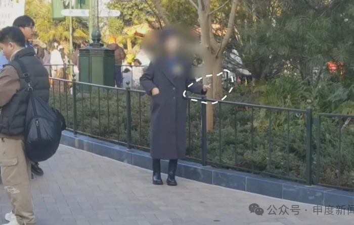 ▲有游客在等待花车巡游期间点燃香烟