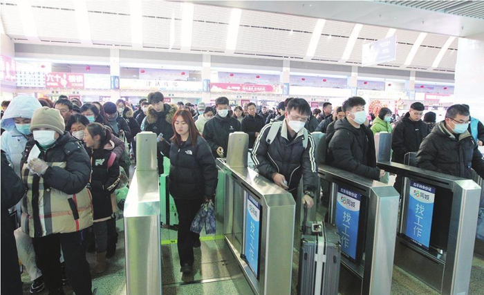         1月14日，沈阳站候车大厅里，旅客们排队进入站台。 本报记者 曲直 摄
