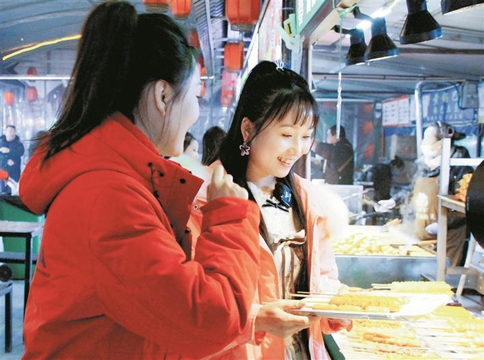     1月16日，顾客在十三师新星市天街步行街夜市选购美食。兵团日报全媒体记者  赵宝山  摄