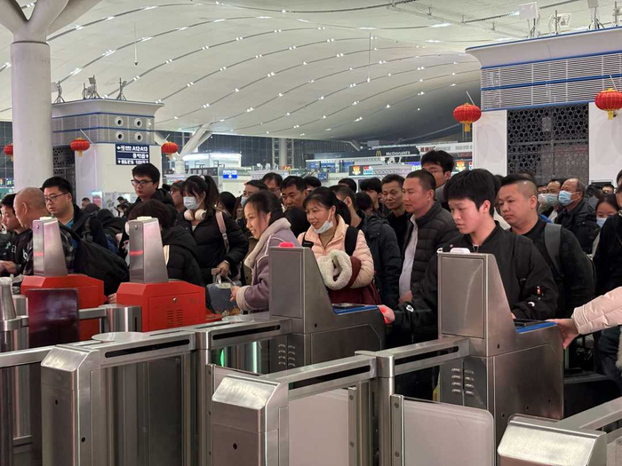 图为深圳北站，乘坐首趟夜间高铁的旅客正在检票。田恬摄
