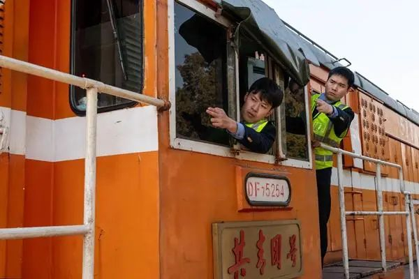 1月25日，武昌南机务段“共青团号”机车包乘组司机长张家文（左）在进行牵引作业前的信号确认。孙旖旎/摄