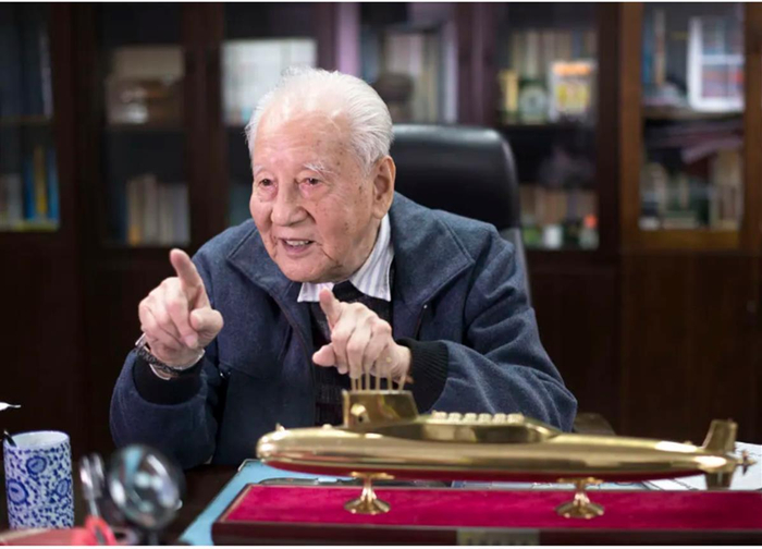 2016年12月20日，黄旭华在办公室内与同事交谈（新华社记者 熊琦 摄）