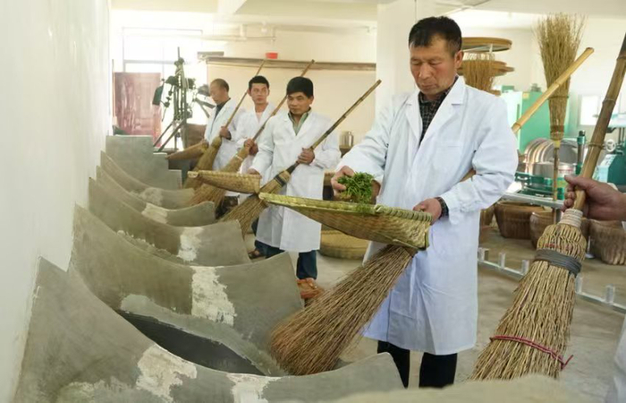 “非遗”传人周家军传授炒茶“非遗”工艺。 受访者供图