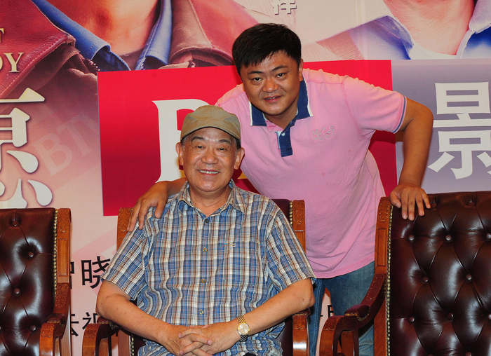 2012年8月29日，高明、高亮父子 图据：视觉中国