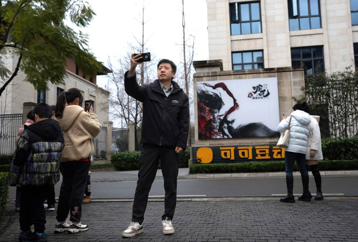 2月8日，影迷们在成都可可豆动画影视有限公司前打卡。新华社 图