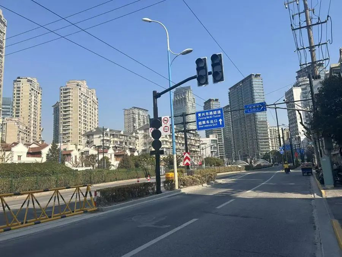 在上层近入口处，夜间特定时间段内，花坛里的隔离栏被拉开，右侧车道上的电动自行车可从该入口驶入，通往上层隧道 束涵 摄