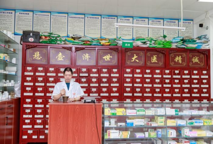 侯俊强在为患者捣药