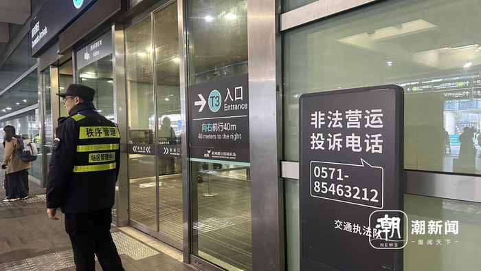 　　萧山机场抵达层“非法营运投诉”指示牌。潮新闻记者 沈译笃 摄