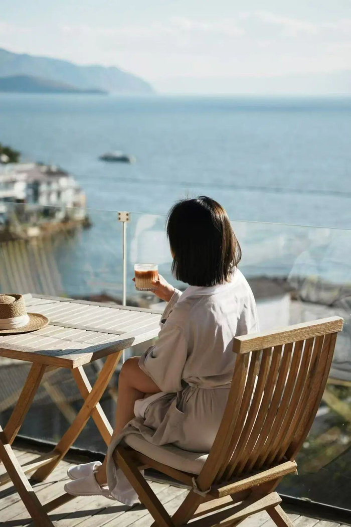 游客在洱海边品咖啡看风景。新华社发 龚加萍/摄