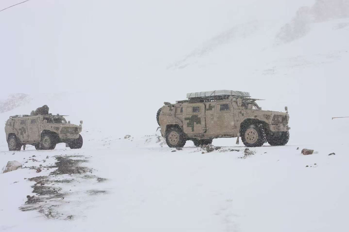 图为巡逻车行驶在风雪中。