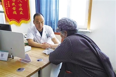 　呼和浩特一社区医生为老人诊断。马妍摄