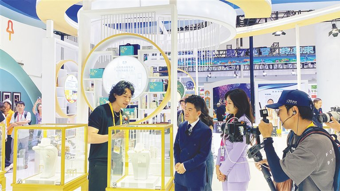 “与辉同行”主播董宇辉在消博会展馆了解产品。海南日报全媒体记者 王晓曈 摄