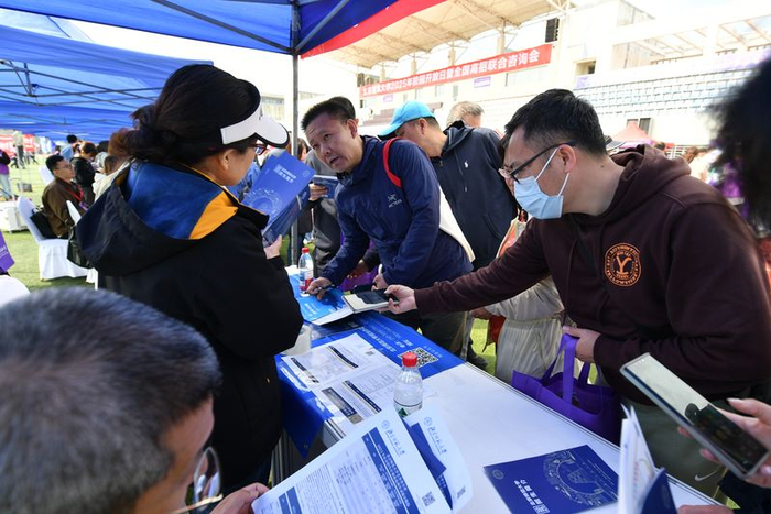 家长在高校展位前咨询招生政策。新京报记者 李木易 摄