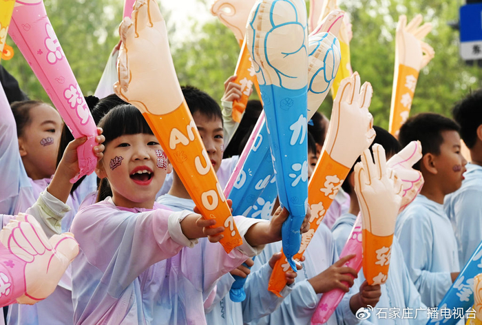 4月20日，2025雄安马拉松鸣枪开跑。赛道外，一群“雄孩子”为跑者加油。河北日报客户端记者 刘光昱 摄